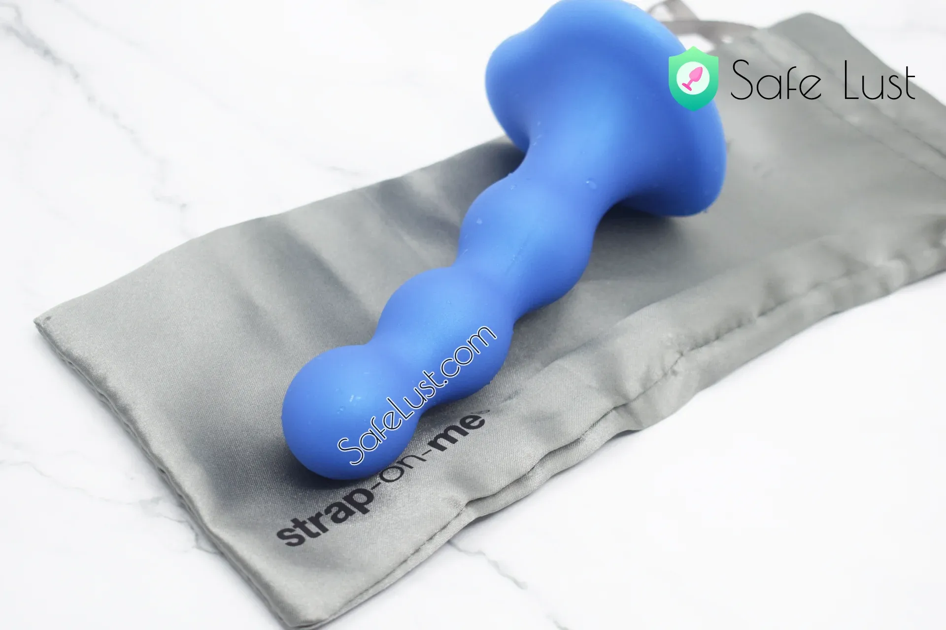 The Hybrid Dildo Plug Balls on its storage pouch